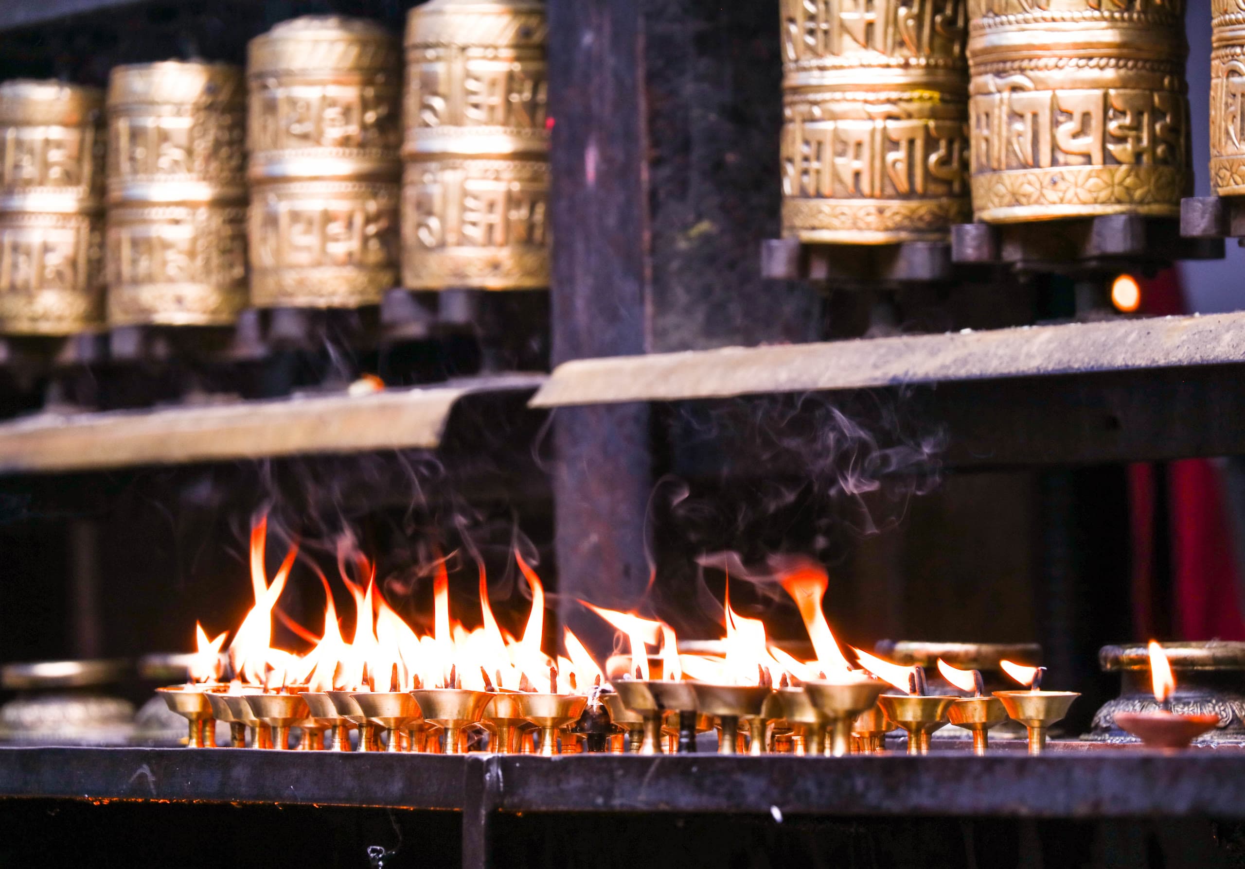 Sacred brass oil lamps burning brightly on temple steps during Tihar festival of lights