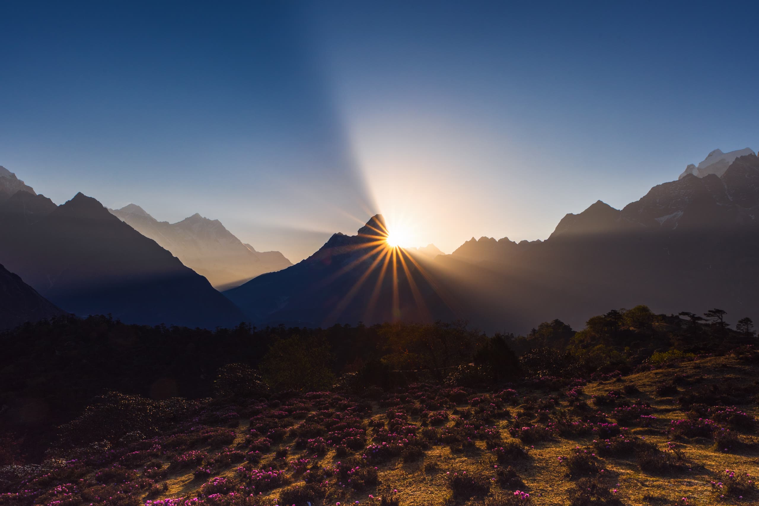 Golden morning sunlight illuminating jagged Himalayan ice walls and glacial ridges at dawn